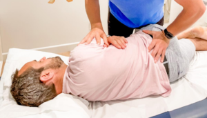 chiropractor adjusts males spine