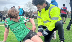 Simon treating Battersea Ironsides junior as part of Pitch-Side Physiotherapy support offered by Nordic Balance in Battersea