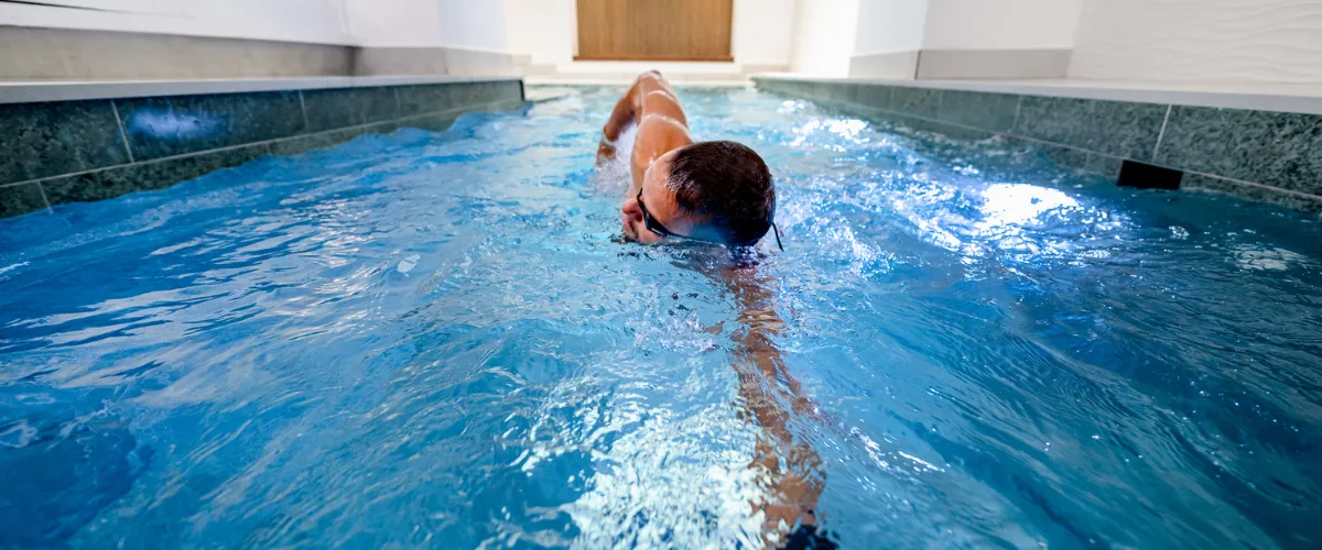 Swimmer training in the Nordic Balance St. James's pool using the Fastlane current system.