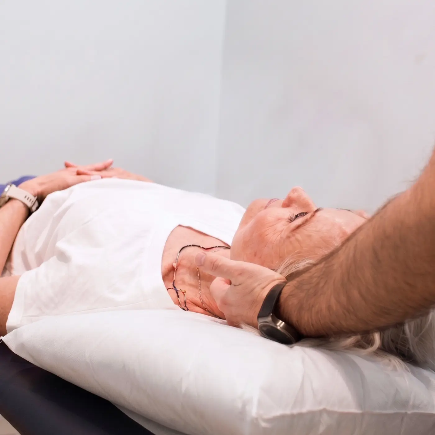 Cranial osteopathy assessment at Nordic Balance, with an osteopath gently positioning a patient’s head while lying on a treatment table.